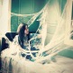 girl in bed covered in cobwebs